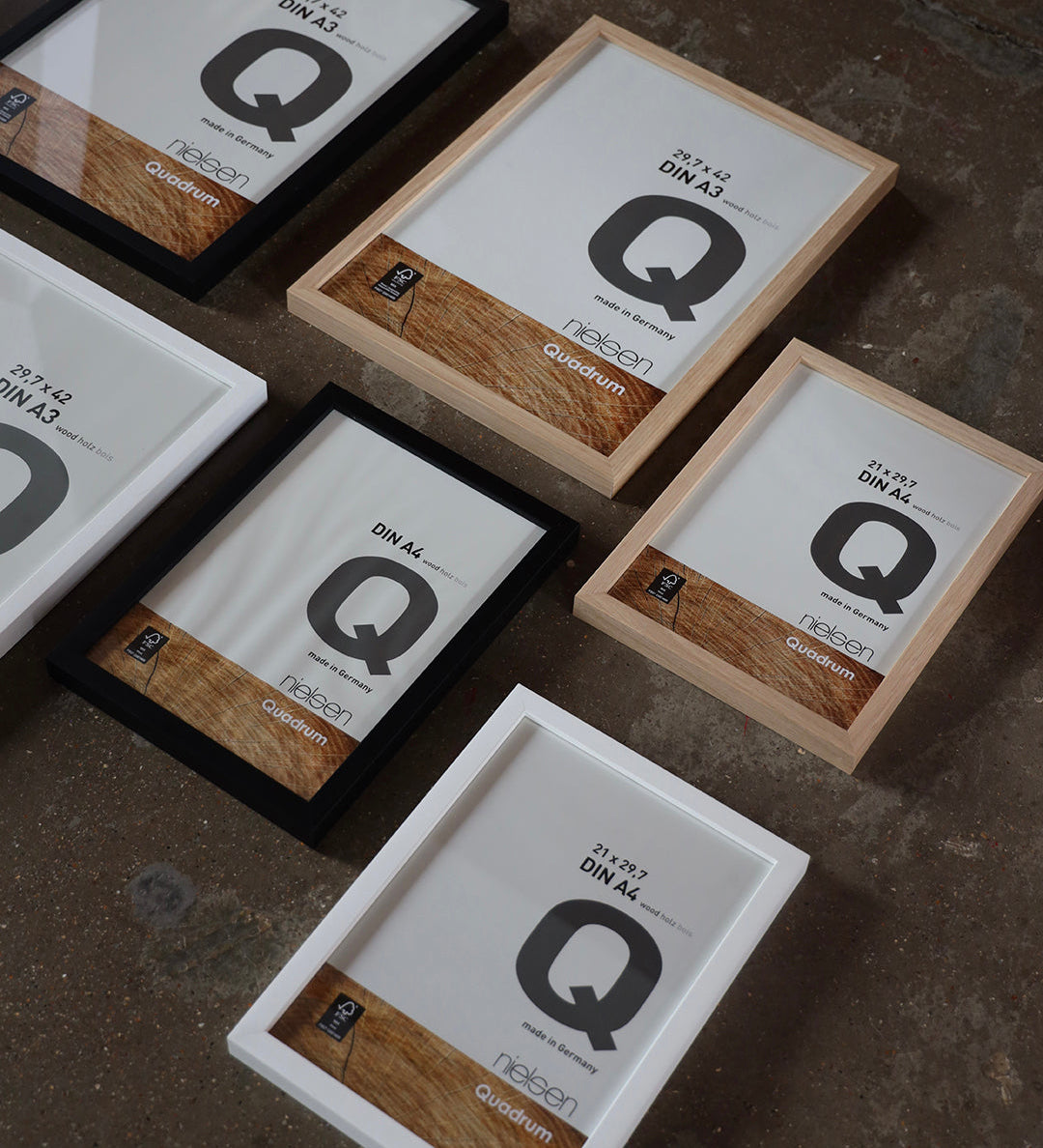 Mixed sizes of Nielsen Quadrum picture framesin Oak, black and white